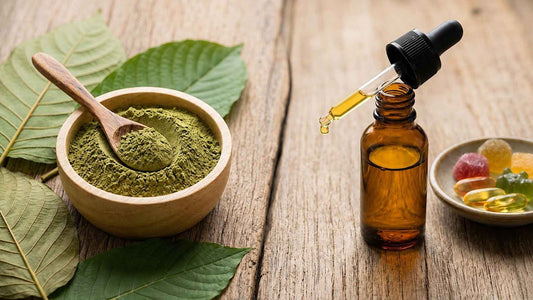 Bowl of kratom powder next to CBD oil dropper bottle